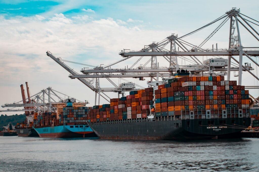 Freight containers stacked at a port, representing exports from Punjab to overseas buyers